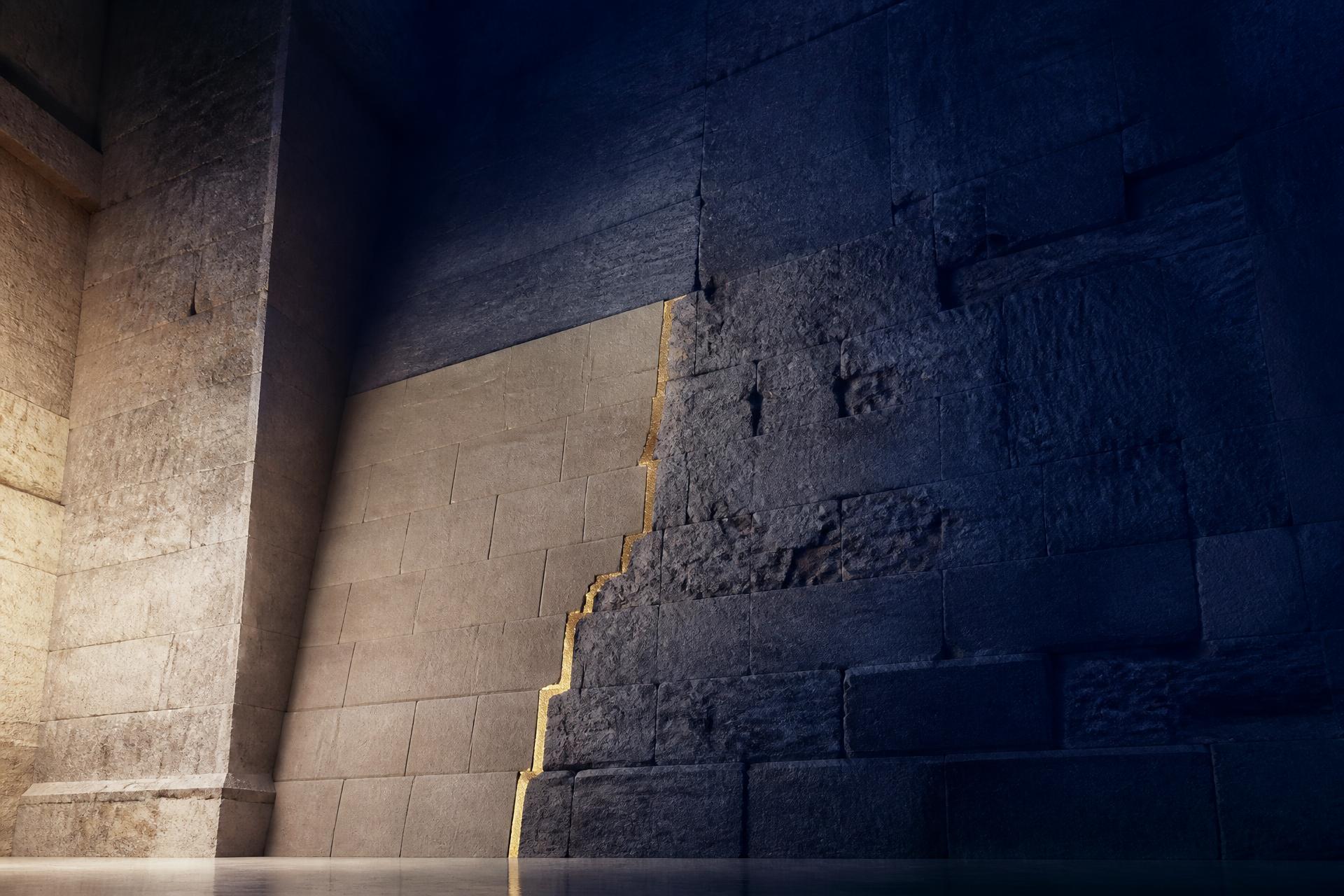 A stone wall rebuilt where it had broken, the joint traced in a thin line of gold